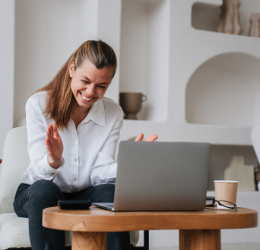 business woman grinning looking into laptop